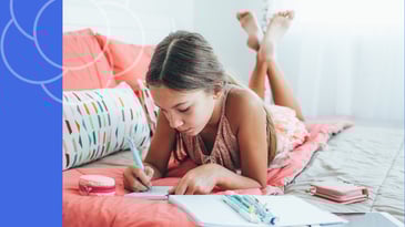 Confident tween girl journaling at home as part of Bloomster course activity
