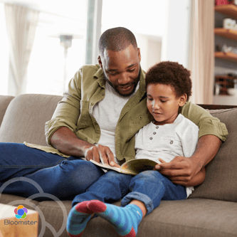 Parent and tween writing in curiosity journals on the couch