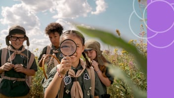 Tween exploring with a magnifying glass, symbolizing curiosity.
