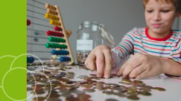 Tween learning money skills by budgeting allowance at home.