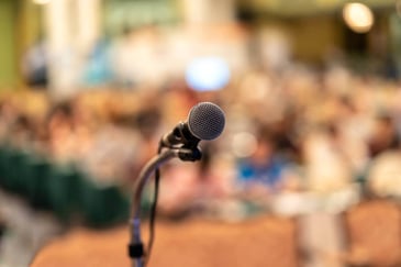 microphone on stage overlooking crowd